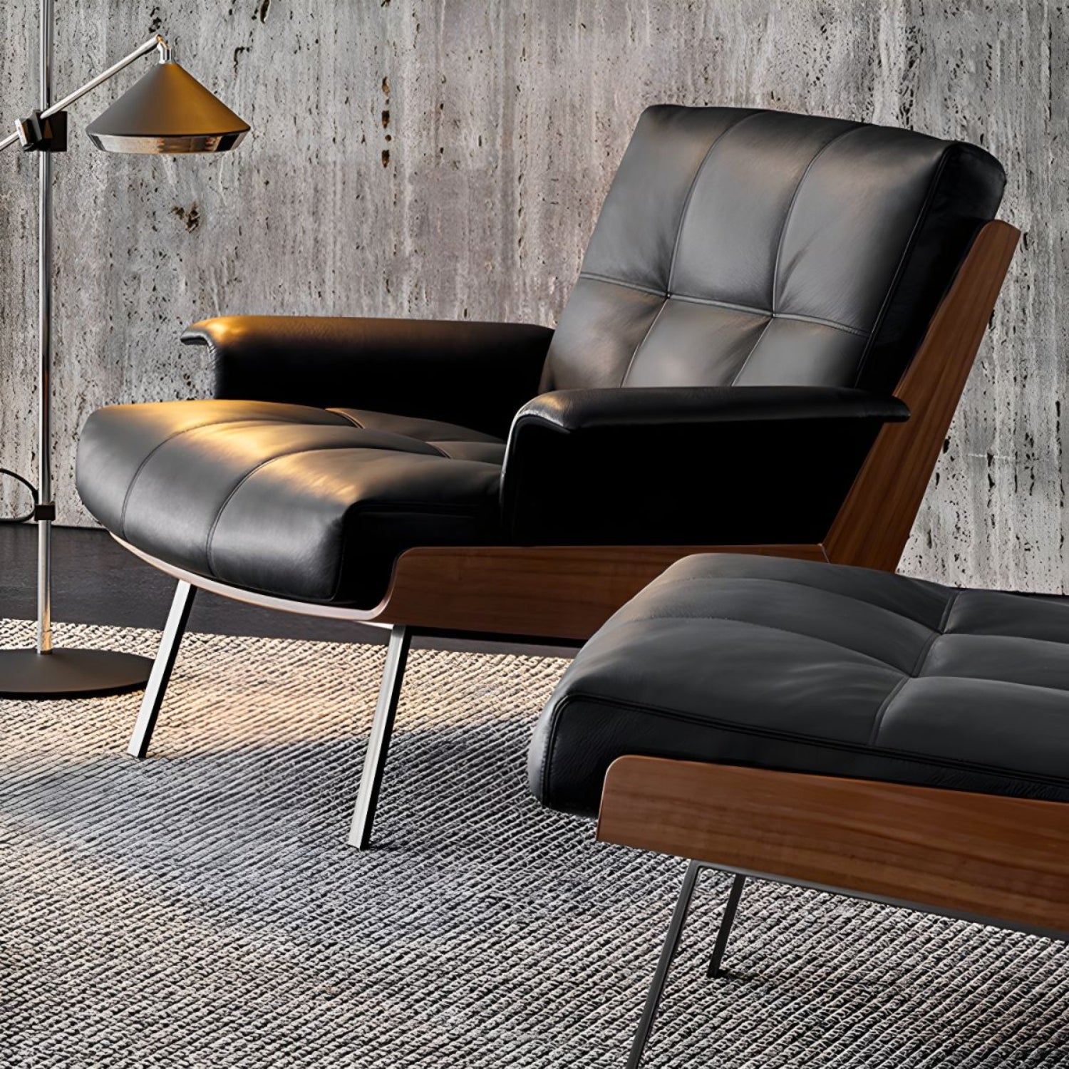 An elegant Replica Daiki black leather lounge chair and ottoman positioned against a wall.