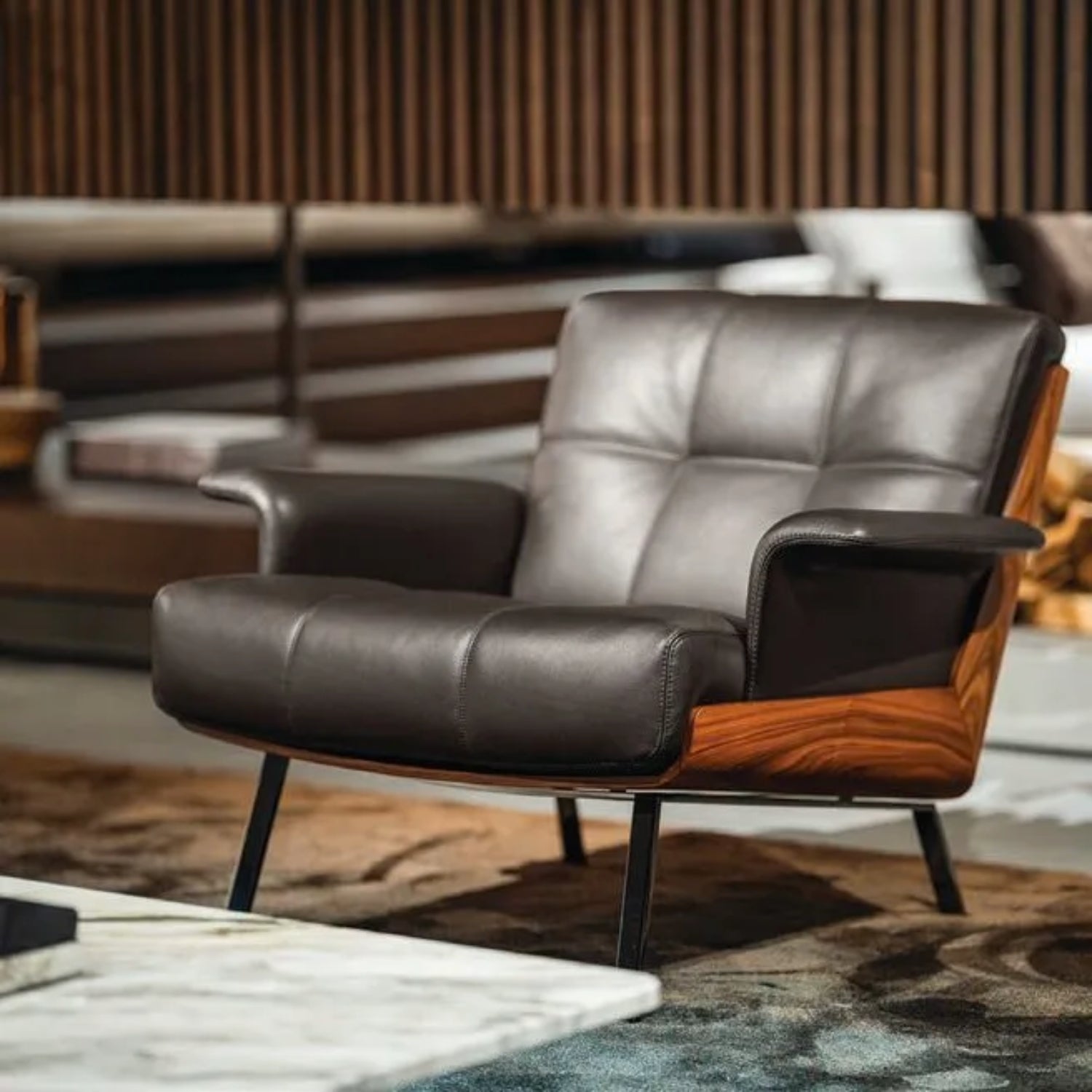 Replica Daiki sleek black leather lounge armchair in contemporary space.