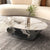 A black ball sits underneath a marble coffee table called Cavalleto.