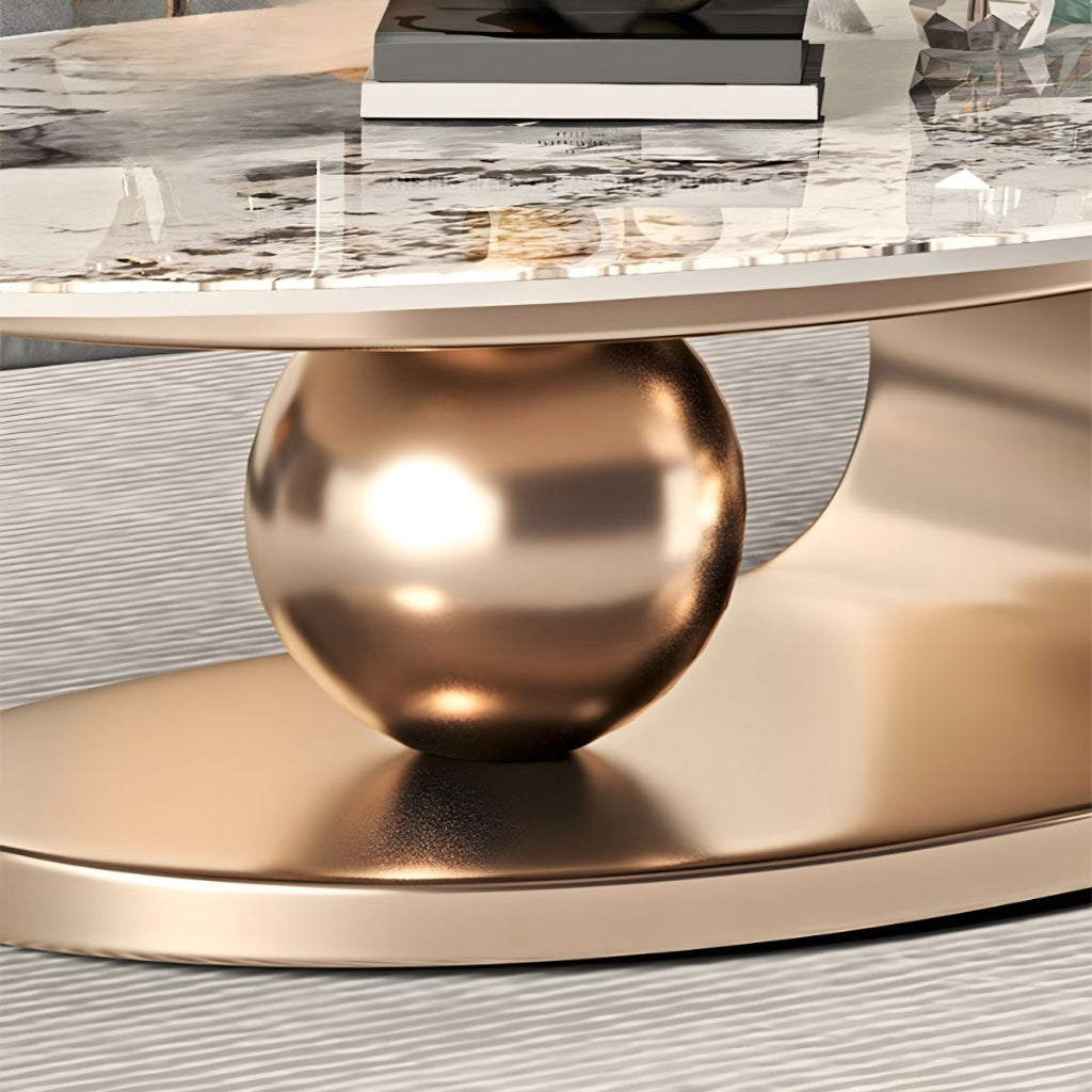 A Cavalleto gold coffee table with a shiny gold ball underneath it.