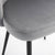 A detailed view of a grey chair with black legs showcasing a willa arlo grey velvet dining chair seat.