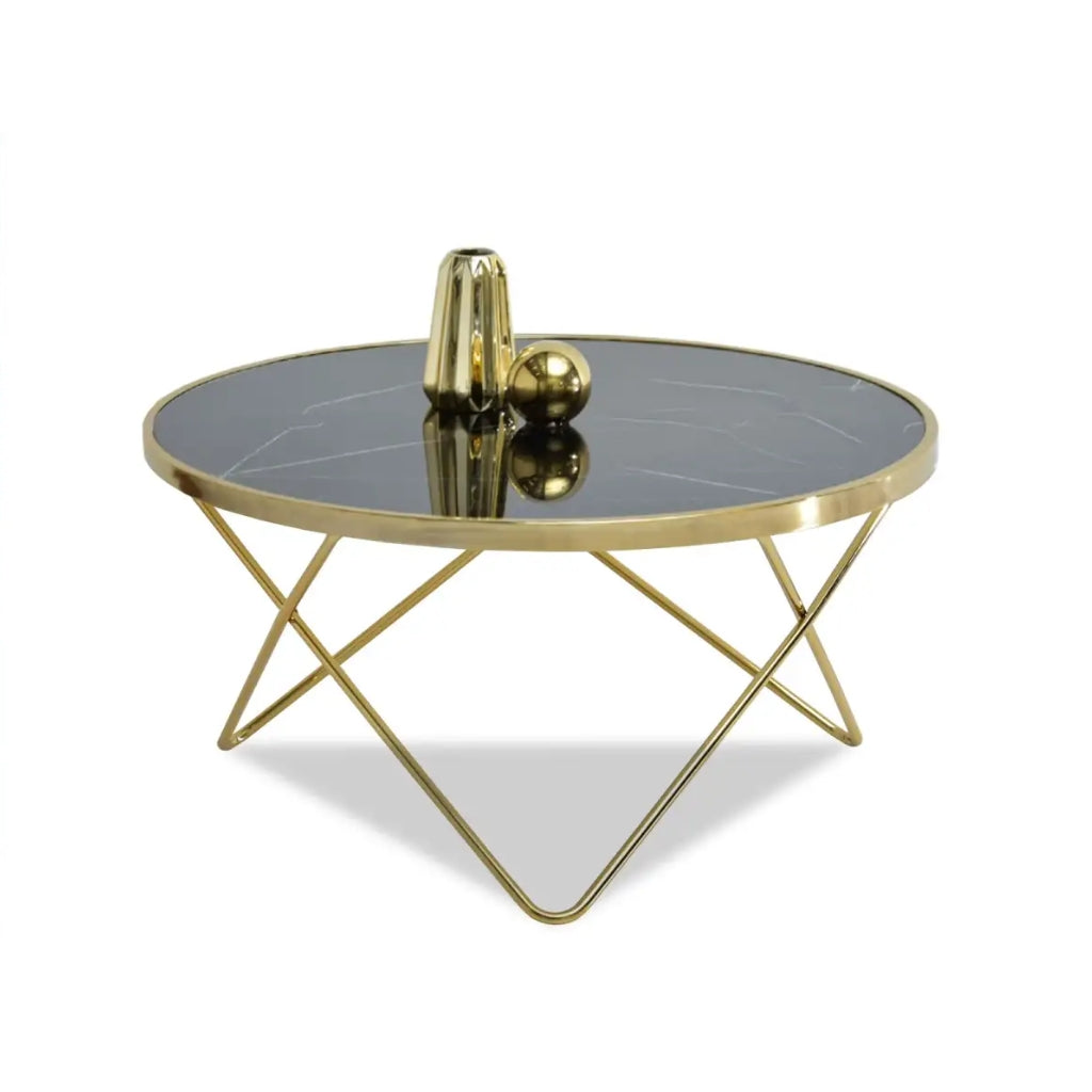 a luxurious gold coffee table with a sleek black marble top