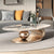 A modern living room with a marble coffee table named Cavalleto gold.