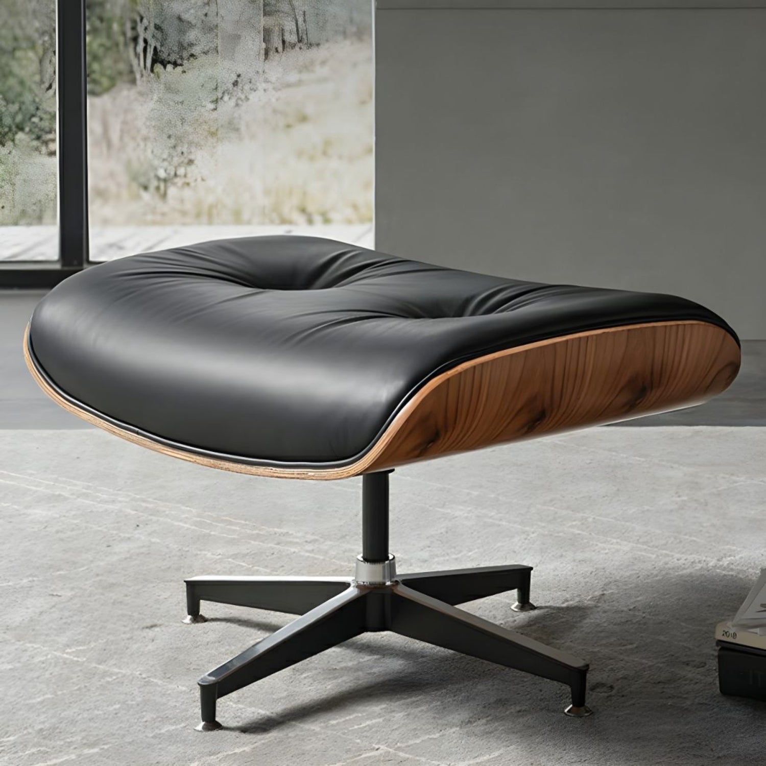 A stylish Eames ottoman featuring a black leather seat and elegant wooden legs, perfect for adding sophistication to any room.