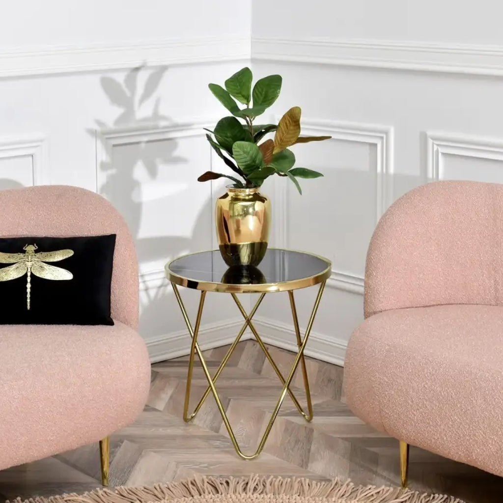 A stylish gold metal side table with a marble top, perfect for adding elegance to any room.
