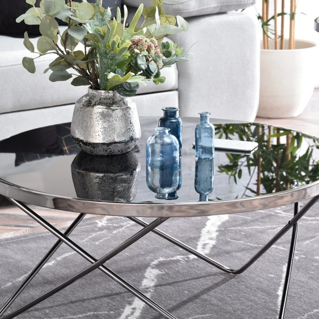 Aden mirror glass coffee table in silver with metal base.