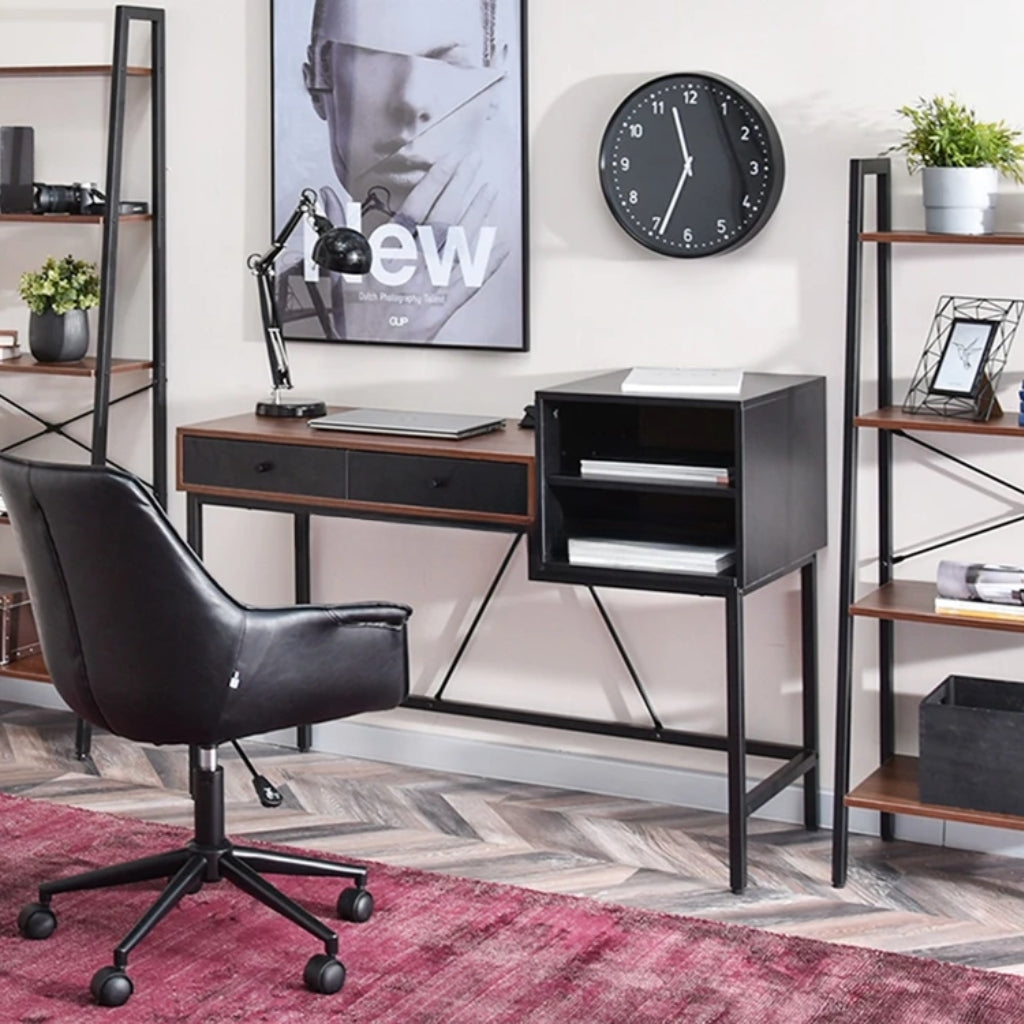 Black and brown Bloomsbury Writing Desk in a workspace with shelves side view.