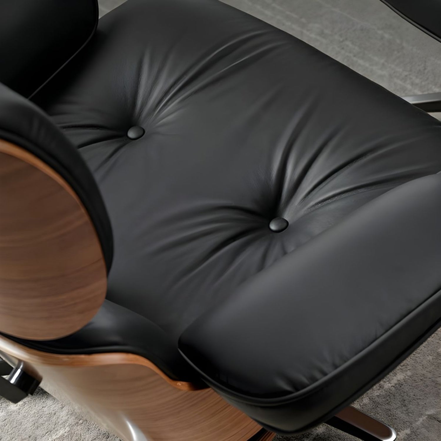 Black leather Eames lounge chair on wooden base.