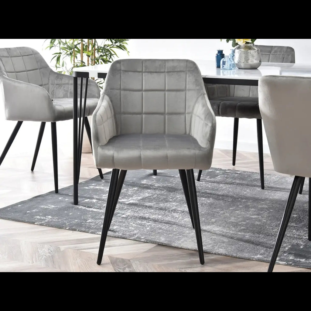 Campbell grey velvet dining chair with black legs and table.