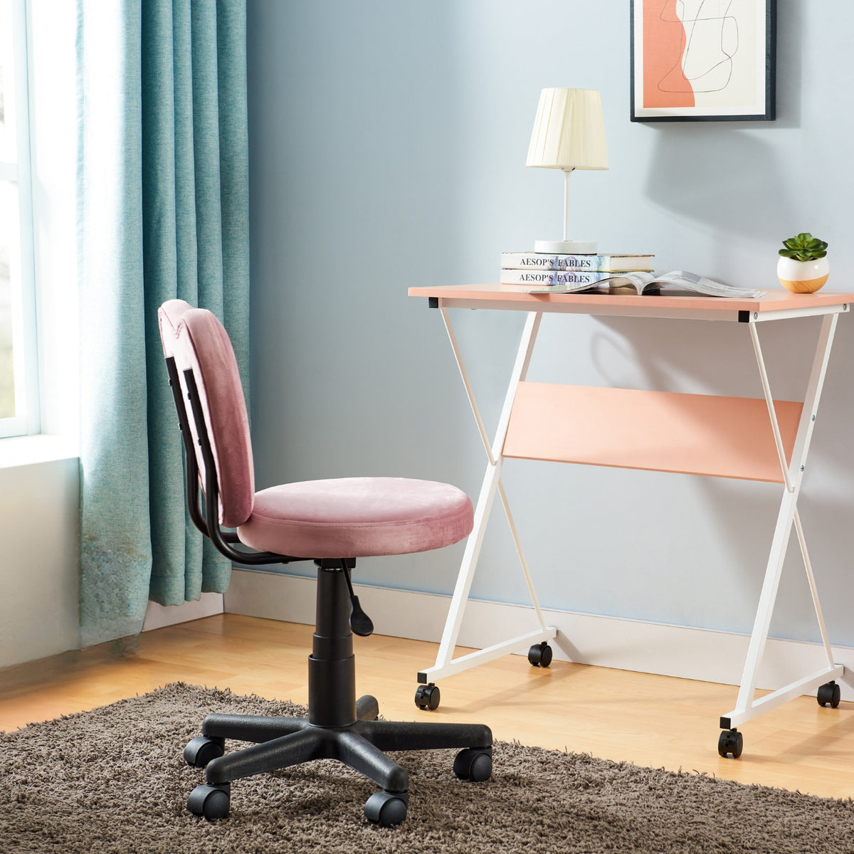 Chatka pink velvet chair and desk in a room with a cozy vibe.