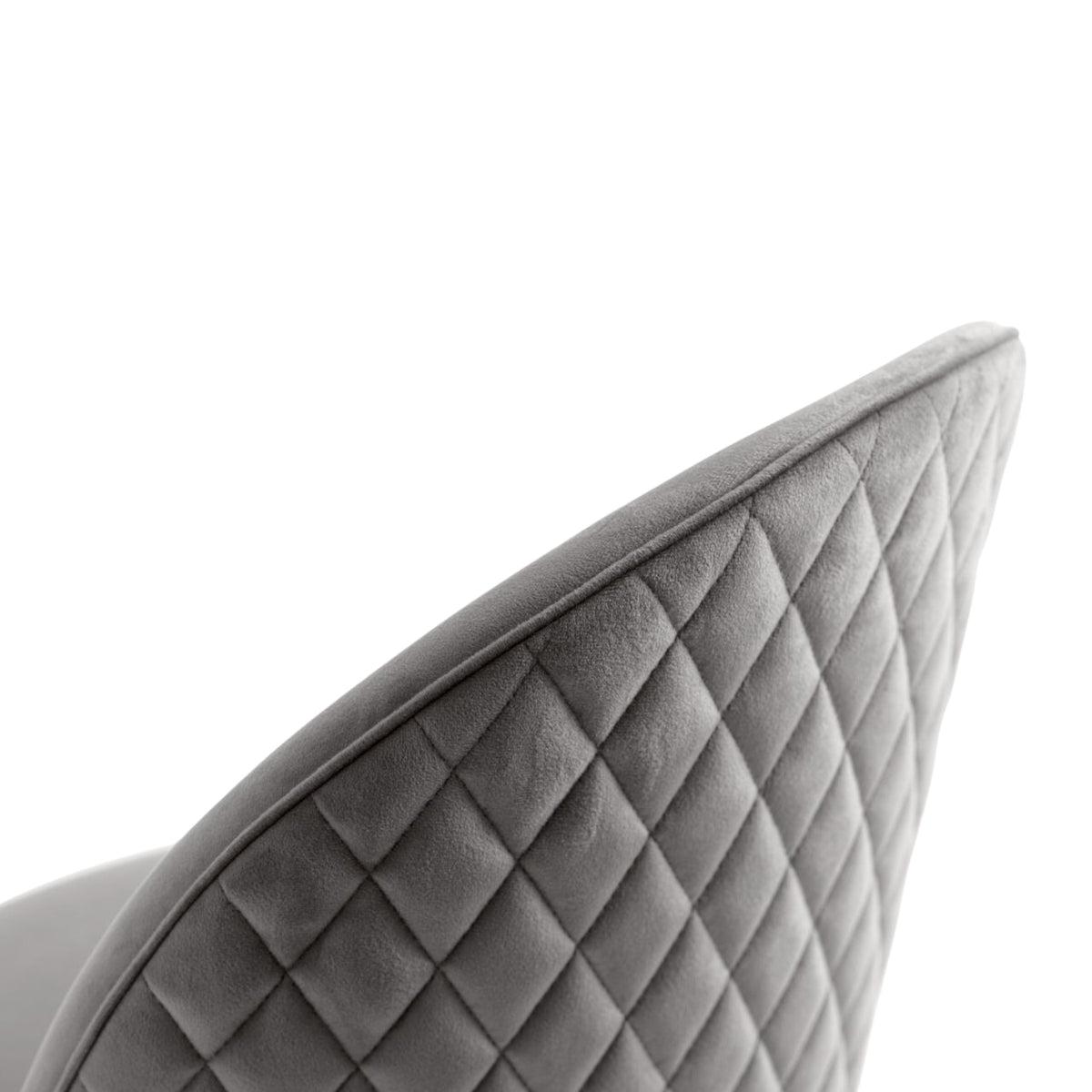 Closeup of a grey quilted seat on a willa arlo dining chair with a diamond stitch back.