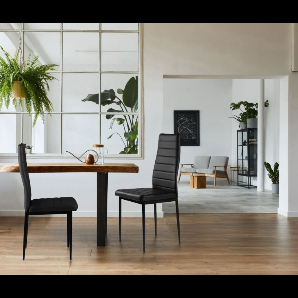 East Urban stylish black pu chairs in a contemporary dining area with a table and chairs.