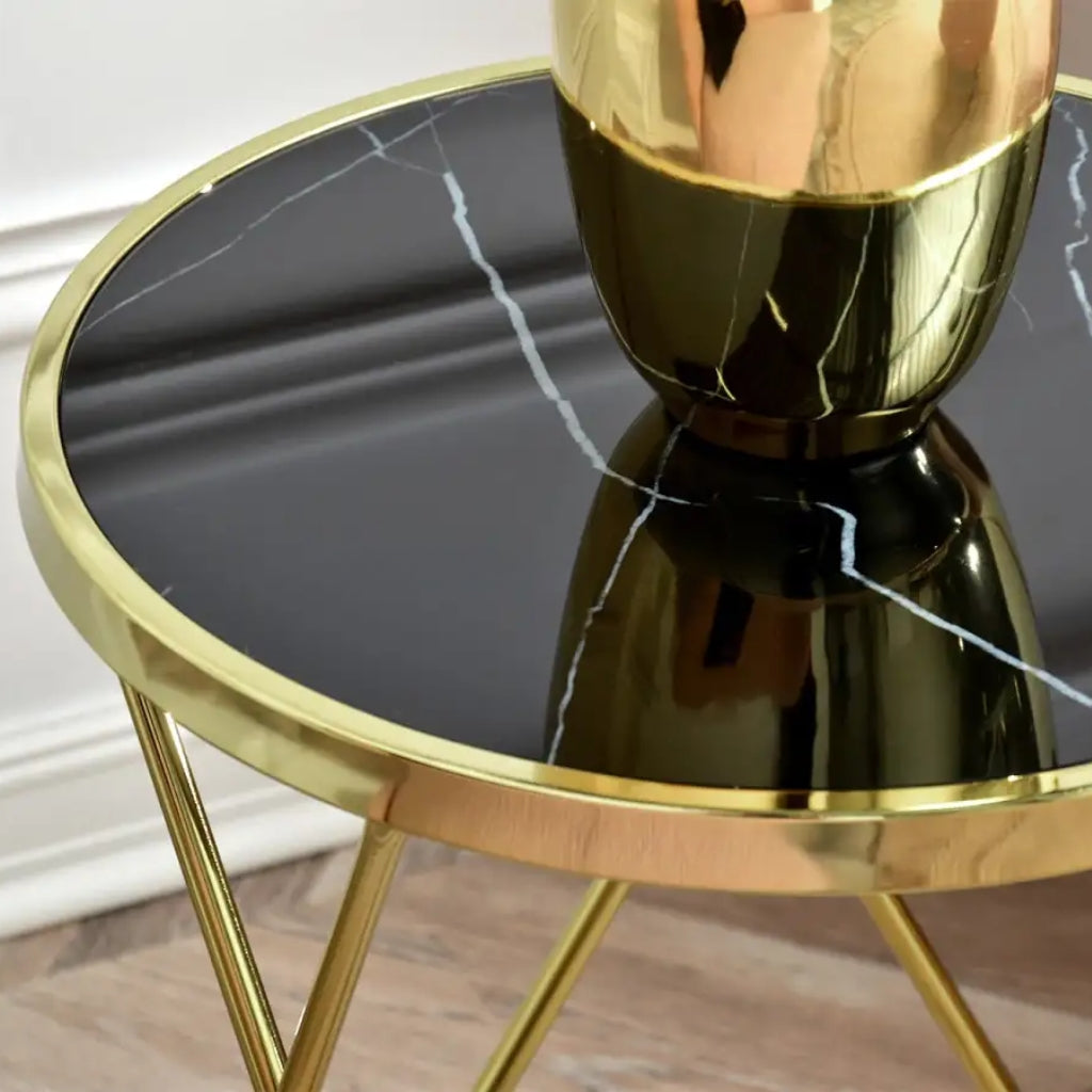 Enhance your space with the Aden Black top Gold End Table, a stunning gold metal side table with a marble top.