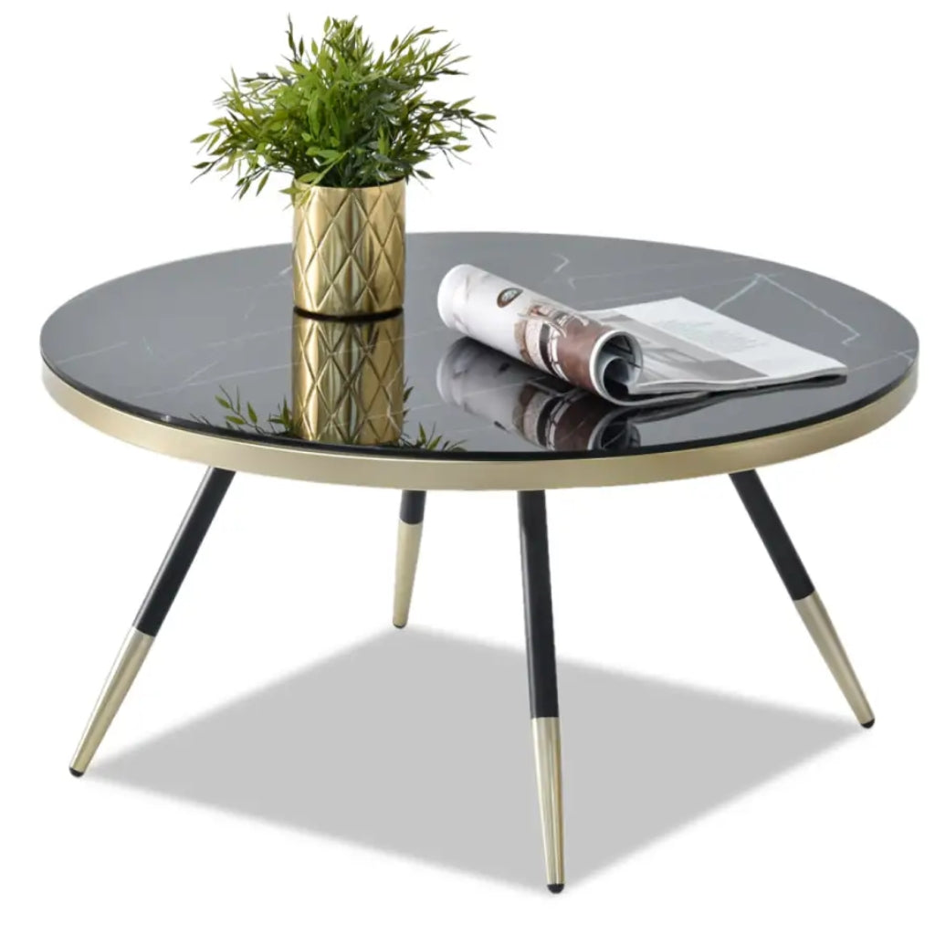 Estella black coffee table featuring elegant gold legs and a stylish black marble top.