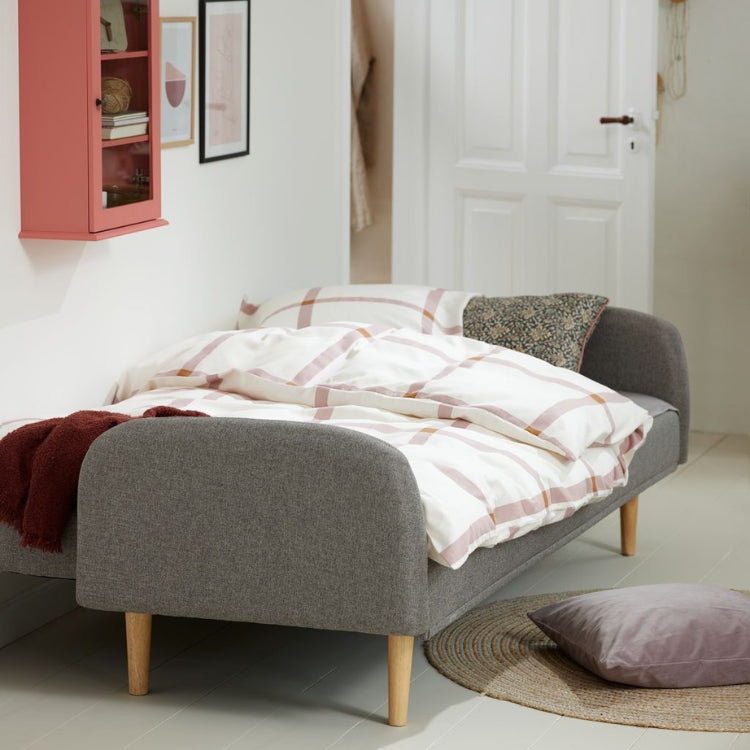 Harlow sleeper sofa opened as a bed with duvets and pillows
