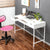 kiana writing desk with a pink chair and a laptop creating a stylish and functional workspace