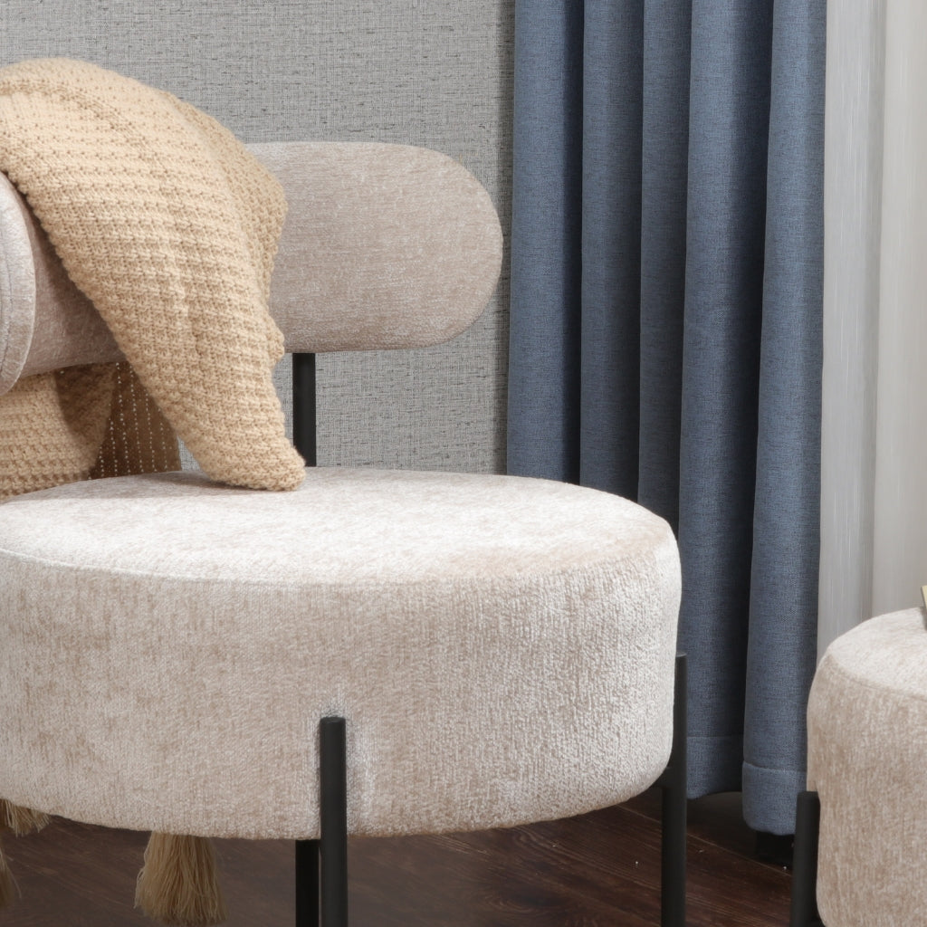 Monroe cozy chair and stool covered with a blanket.