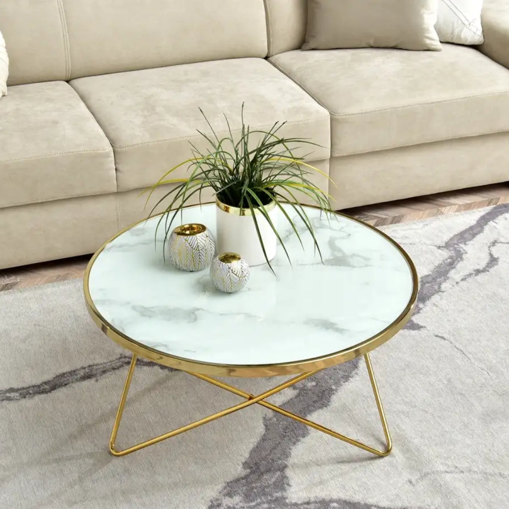 Stylish Aden coffee table featuring white marble top and sleek gold metal legs.