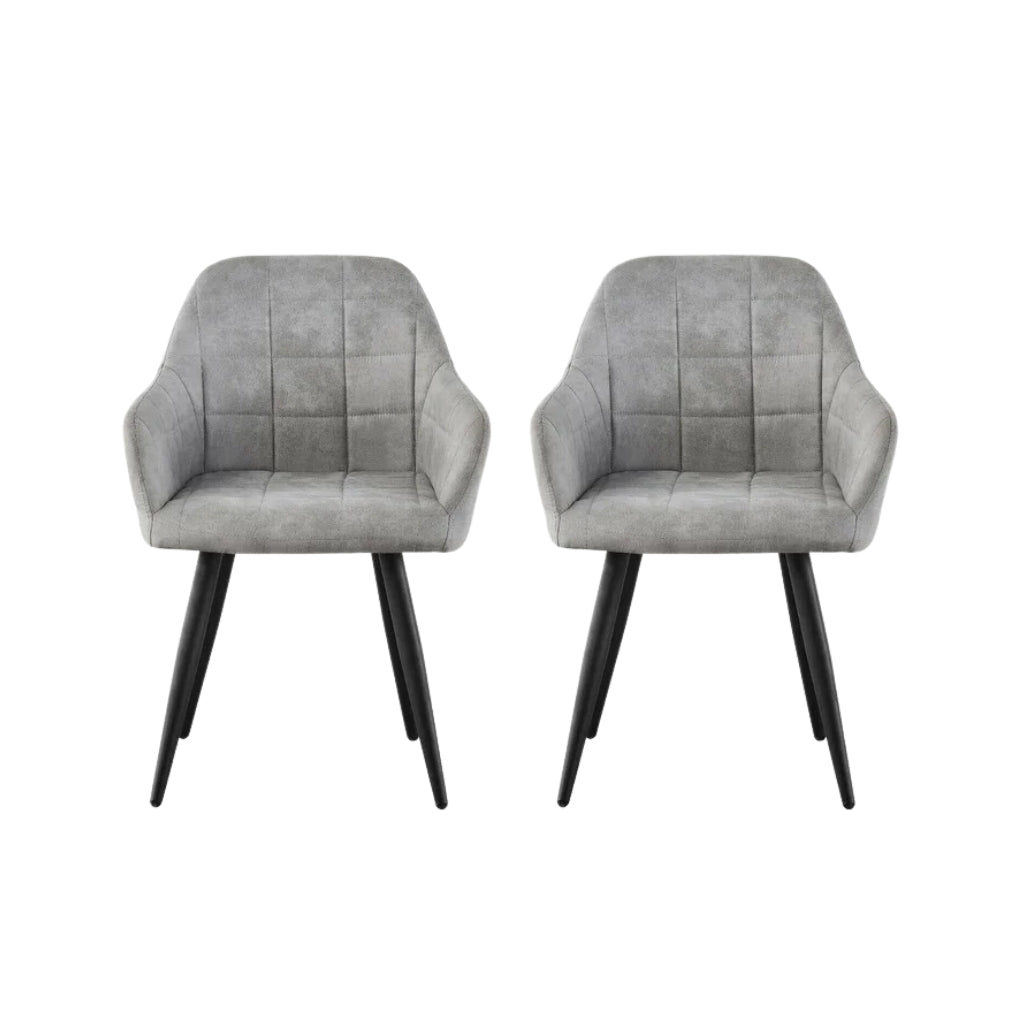 Two campbell grey velvet dining chairs with sleek black legs.