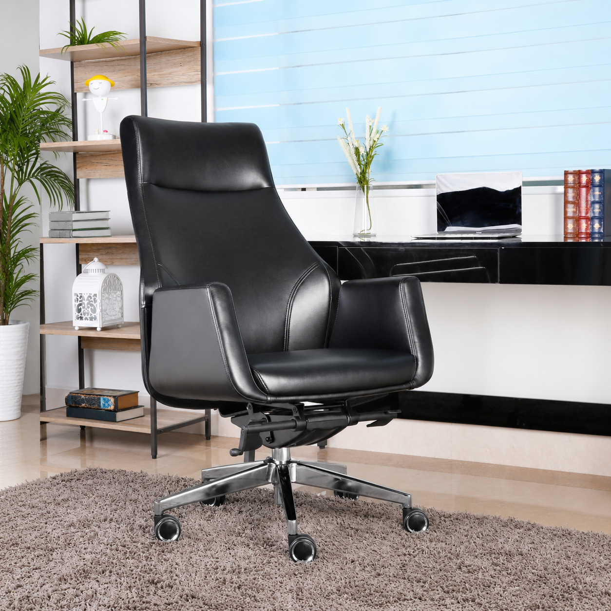 Front view of the Winston Porter black executive office chair with a high back, padded armrests and chrome five-star base.